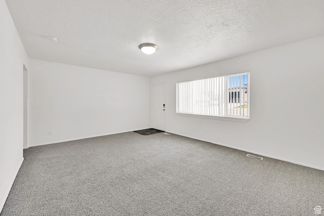 10679 S 2200 W, South Jordan, UT 84095 - spare room featuring a textured ceiling, dark carpet, and baseboards