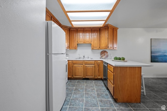 58 S 900 E, Spanish Fork, UT 84660 - kitchen featuring a peninsula, freestanding refrigerator, a sink, stainless steel dishwasher, and light countertops