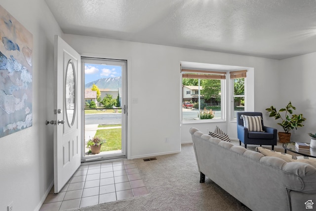 58 S 900 E, Spanish Fork, UT 84660 - foyer featuring a textured ceiling, baseboards, light colored carpet, and light tile patterned flooring