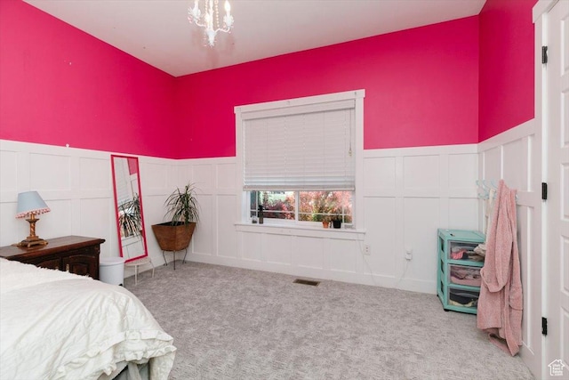 225 E 620 S, Smithfield, UT 84335 - carpeted bedroom featuring a decorative wall, a wainscoted wall, and a chandelier