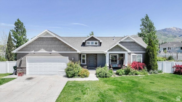 225 E 620 S, Smithfield, UT 84335 - craftsman house featuring stone siding, a garage, concrete driveway, covered porch, and a mountain view