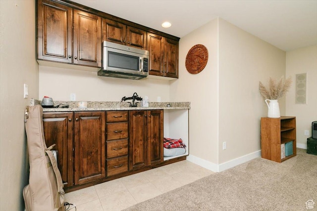 225 E 620 S, Smithfield, UT 84335 - kitchen featuring stainless steel microwave, baseboards, light stone counters, and light colored carpet