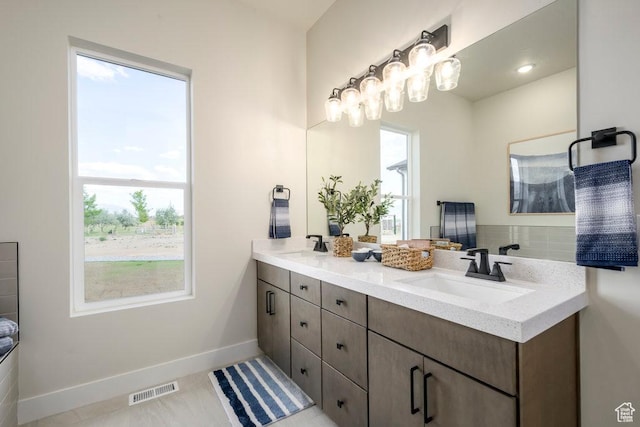 1104 N Windflower Ln Unit 127, Grantsville, UT 84029 - full bathroom with double vanity, healthy amount of natural light, and baseboards