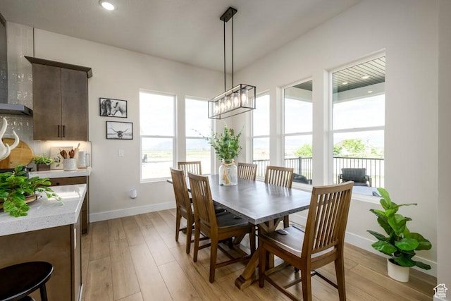 1104 N Windflower Ln Unit 127, Grantsville, UT 84029 - dining space with baseboards, light wood finished floors, a chandelier, and recessed lighting