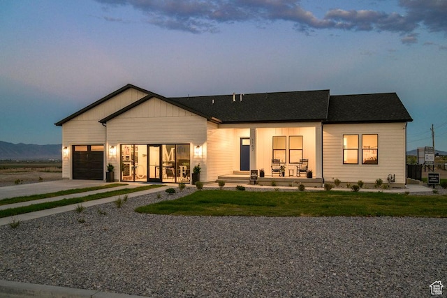 1104 N Windflower Ln Unit 127, Grantsville, UT 84029 - view of front of house with driveway, an attached garage, a shingled roof, and a yard