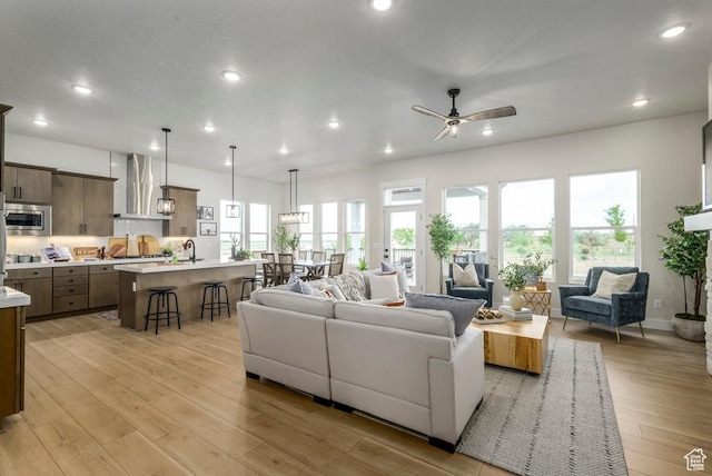 1104 N Windflower Ln Unit 127, Grantsville, UT 84029 - living area with a ceiling fan, plenty of natural light, recessed lighting, and light wood-type flooring