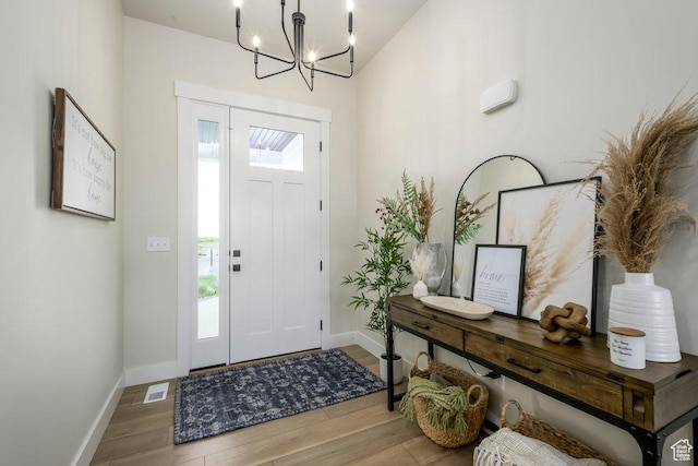 1104 N Windflower Ln Unit 127, Grantsville, UT 84029 - entryway featuring wood finished floors, baseboards, and a chandelier