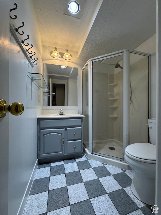 4440 W 6095 S, Taylorsville, UT 84118 - bathroom featuring vanity, toilet, a stall shower, baseboards, and a textured ceiling