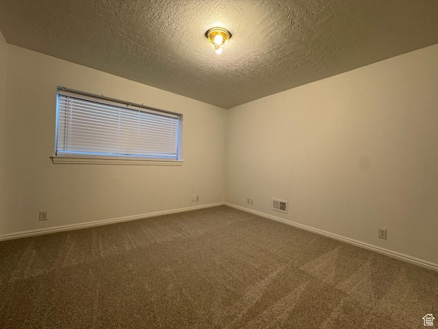 4440 W 6095 S, Taylorsville, UT 84118 - spare room featuring dark carpet, a textured ceiling, and baseboards