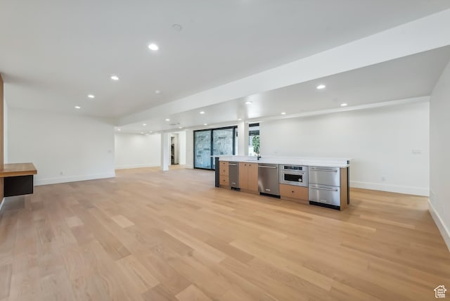 3035 Corral Peak Cir Unit 148, Heber City, UT 84032 - kitchen featuring stainless steel appliances, light wood finished floors, baseboards, open floor plan, and recessed lighting