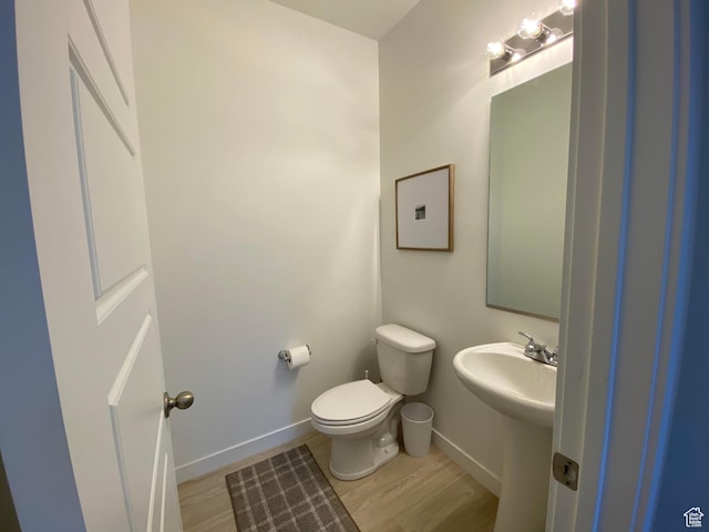 2132 N Elderberry Dr W, Saratoga Springs, UT 84045 - half bath featuring wood finished floors, toilet, baseboards, and a sink