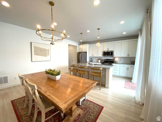 2132 N Elderberry Dr W, Saratoga Springs, UT 84045 - dining area with light wood-type flooring, a chandelier, recessed lighting, and baseboards