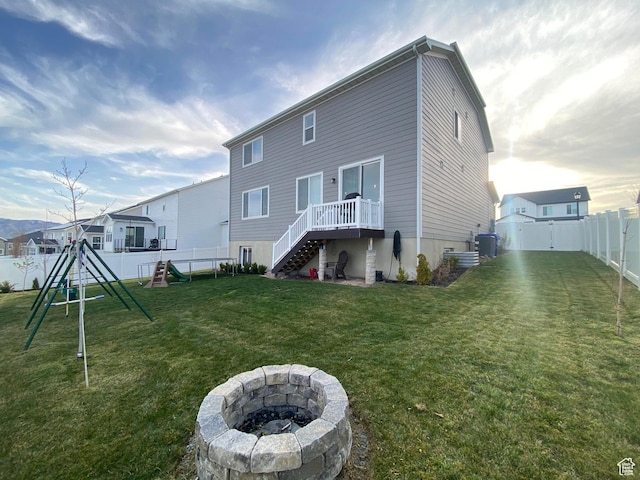 2132 N Elderberry Dr W, Saratoga Springs, UT 84045 - back of property with a fire pit, central AC unit, a playground, and stairway