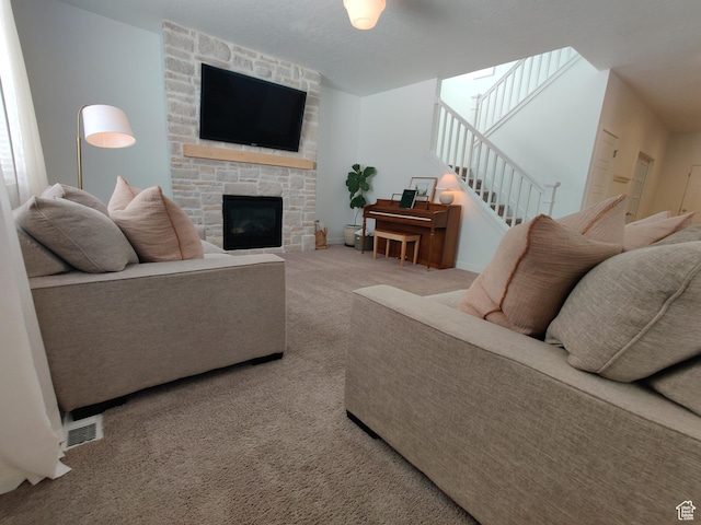 2132 N Elderberry Dr W, Saratoga Springs, UT 84045 - carpeted living area with a fireplace, stairs, and baseboards