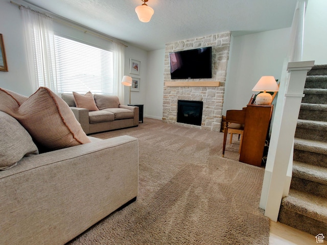 2132 N Elderberry Dr W, Saratoga Springs, UT 84045 - living area featuring stairway, a fireplace, carpet flooring, and a textured ceiling