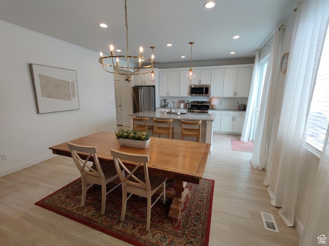 2132 N Elderberry Dr W, Saratoga Springs, UT 84045 - dining room featuring light wood-style floors, a chandelier, recessed lighting, and baseboards