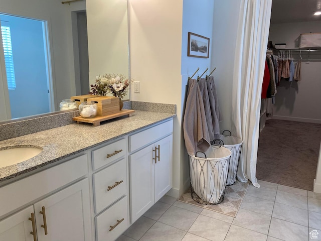 2132 N Elderberry Dr W, Saratoga Springs, UT 84045 - full bath with double vanity, a walk in closet, tile patterned floors, and baseboards