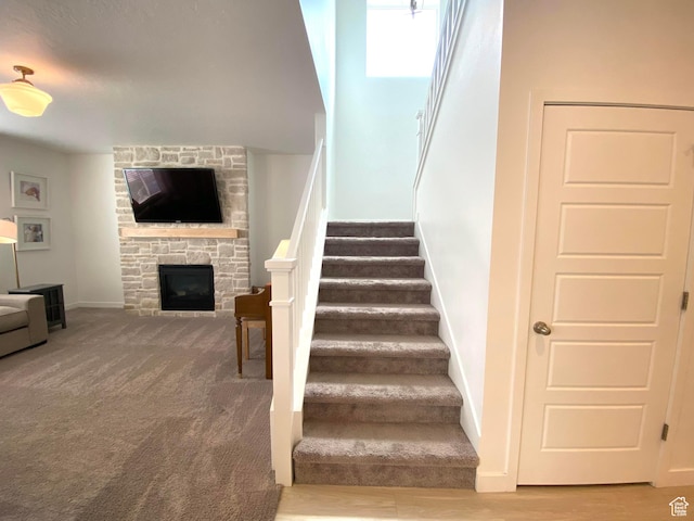 2132 N Elderberry Dr W, Saratoga Springs, UT 84045 - stairs with a stone fireplace and baseboards