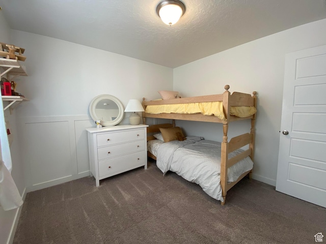 2132 N Elderberry Dr W, Saratoga Springs, UT 84045 - bedroom with dark carpet, a textured ceiling, and a wainscoted wall
