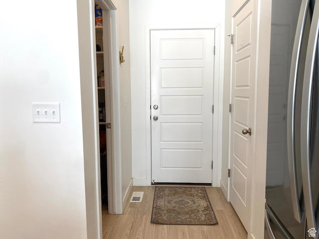 2132 N Elderberry Dr W, Saratoga Springs, UT 84045 - doorway with light wood-style flooring and baseboards