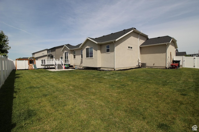 1457 W 400 S, Syracuse, UT 84075 - rear view of property featuring a playground, stucco siding, a deck, central AC, and a gate