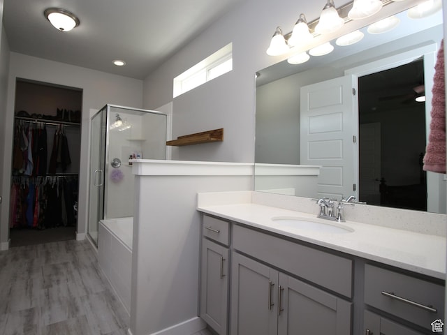 1457 W 400 S, Syracuse, UT 84075 - full bath featuring a shower stall, vanity, a walk in closet, wood finished floors, and baseboards