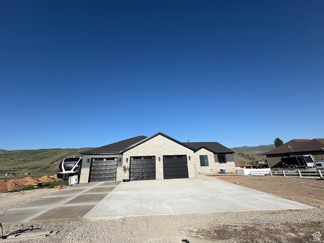 19722 Elkhorn Cir, Birdseye, UT 84629 - view of front facade with a garage, driveway, and a mountain view