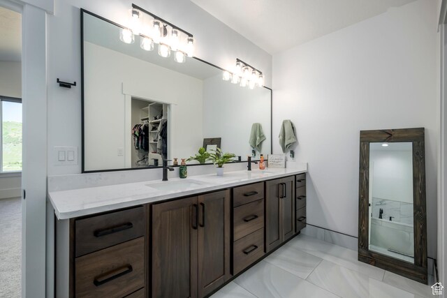 19722 Elkhorn Cir, Birdseye, UT 84629 - bathroom featuring double vanity, marble finish floors, a walk in closet, and a shower