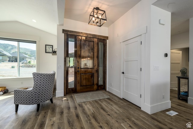 19722 Elkhorn Cir, Birdseye, UT 84629 - foyer entrance featuring wood finished floors, vaulted ceiling, a chandelier, and baseboards