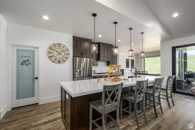 19722 Elkhorn Cir, Birdseye, UT 84629 - kitchen featuring stainless steel refrigerator with ice dispenser, a large island with sink, dark brown cabinets, dark wood-style flooring, and light countertops