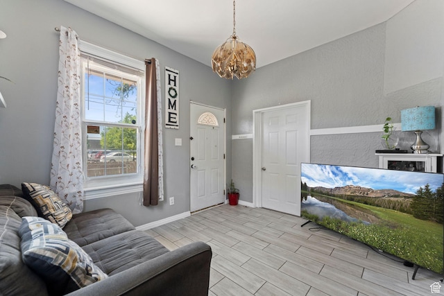 2120 Pingree Ave, Ogden, UT 84401 - living area featuring a chandelier, wood finish floors, and baseboards