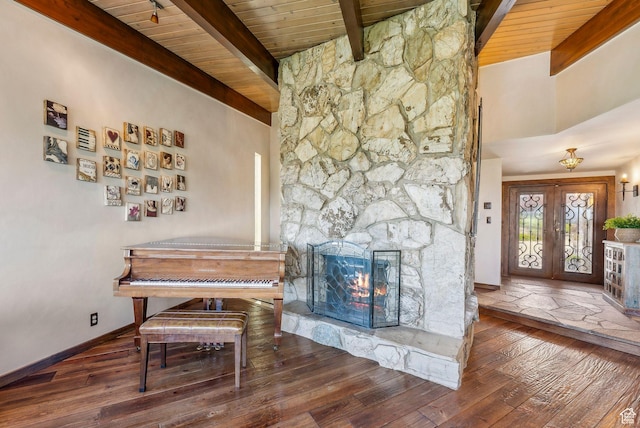 4774 S Oak Terrace Dr, Millcreek, UT 84124 - dining area featuring wooden ceiling with exposed beams, wood-type flooring, a stone fireplace, and baseboards