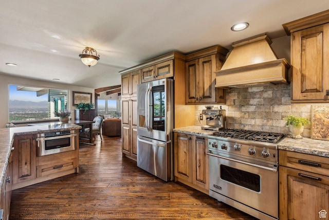 4774 S Oak Terrace Dr, Millcreek, UT 84124 - kitchen featuring stainless steel appliances, custom range hood, dark wood-style floors, brown cabinetry, and recessed lighting