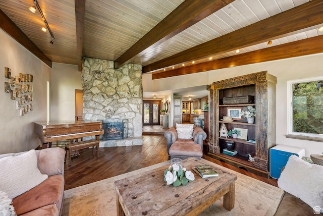 4774 S Oak Terrace Dr, Millcreek, UT 84124 - living area with rail lighting, wood-type flooring, a stone fireplace, and wood ceiling with exposed beams