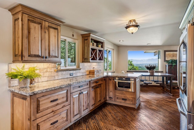 4774 S Oak Terrace Dr, Millcreek, UT 84124 - kitchen featuring stainless steel appliances, dark wood finished floors, a peninsula, backsplash, and brown cabinets