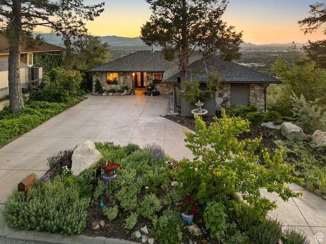4774 S Oak Terrace Dr, Millcreek, UT 84124 - view of front of house featuring stone siding, concrete driveway, a mountain view, and a shingled roof