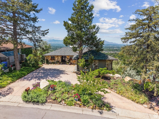 4774 S Oak Terrace Dr, Millcreek, UT 84124 - view of front of house featuring stone siding, concrete driveway, and a mountain view