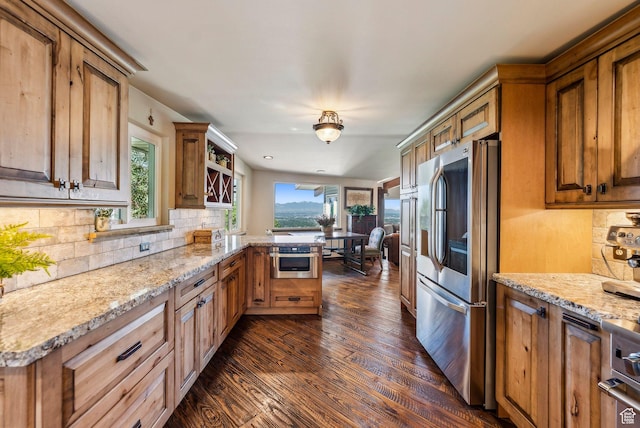 4774 S Oak Terrace Dr, Millcreek, UT 84124 - kitchen with appliances with stainless steel finishes, dark wood-type flooring, tasteful backsplash, a peninsula, and light stone counters