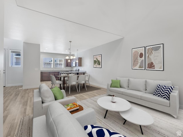 3964 W Hardman Way, Lehi, UT 84043 - living area featuring light wood-style floors, baseboards, and a chandelier