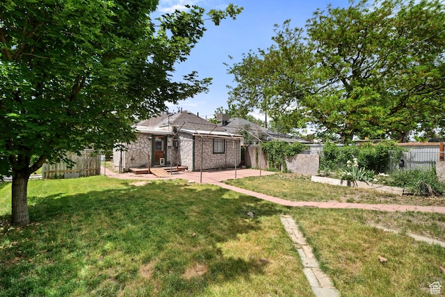 665 S Emery St W, Salt Lake City, UT 84104 - view of front of house with stone siding and a patio area