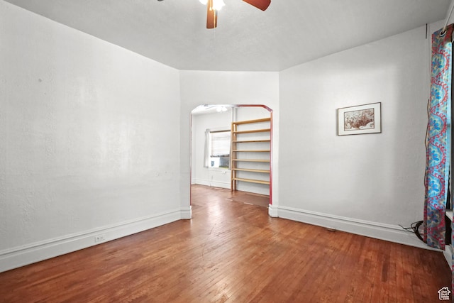 665 S Emery St W, Salt Lake City, UT 84104 - unfurnished room with a ceiling fan, hardwood / wood-style floors, baseboards, and arched walkways