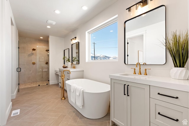 487 W 1200 N, Mapleton, UT 84664 - bathroom with a stall shower, two vanities, a soaking tub, recessed lighting, and baseboards