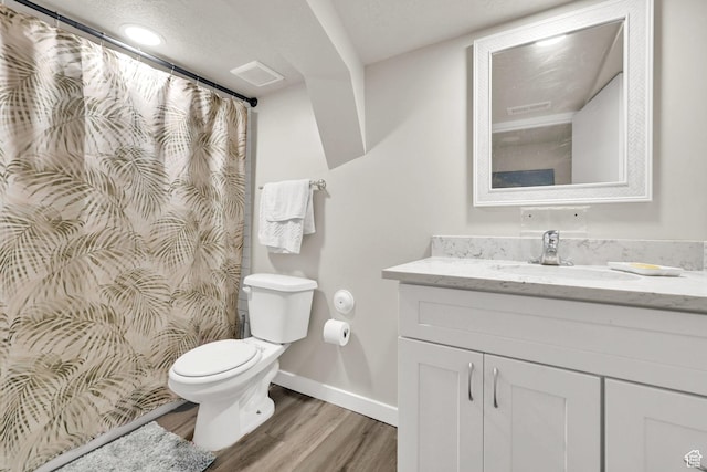 2883 S Brinker Ave E, Ogden, UT 84403 - full bath featuring toilet, vanity, wood finished floors, baseboards, and curtained shower