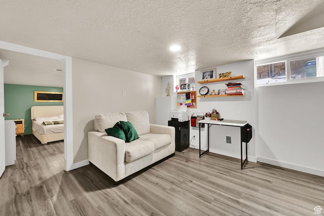 2883 S Brinker Ave E, Ogden, UT 84403 - living room featuring light wood-style flooring, baseboards, and a textured ceiling