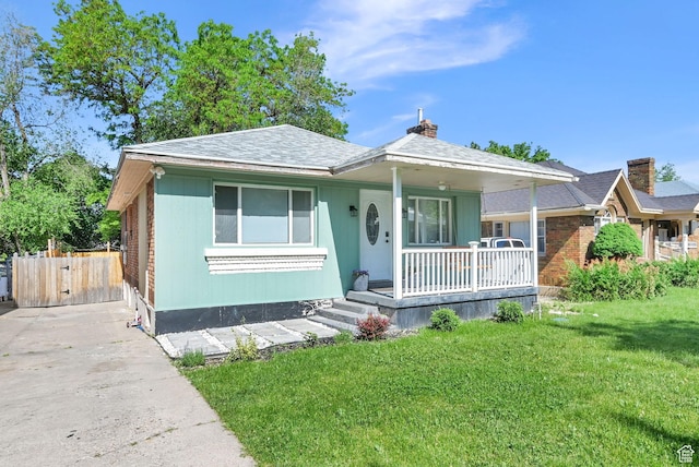 2883 S Brinker Ave E, Ogden, UT 84403 - bungalow-style home featuring covered porch, a front lawn, a chimney, and concrete driveway