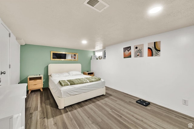 2883 S Brinker Ave E, Ogden, UT 84403 - bedroom with wood finished floors, a textured ceiling, and recessed lighting