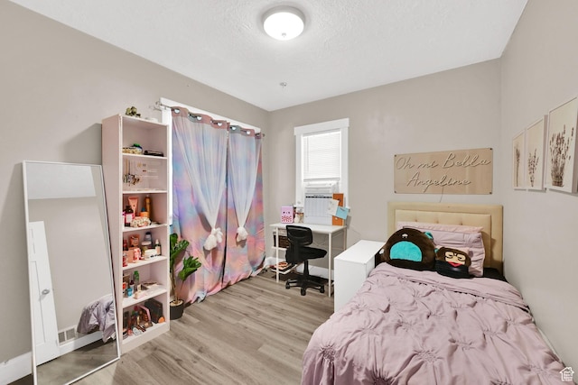 2883 S Brinker Ave E, Ogden, UT 84403 - bedroom featuring light wood finished floors, a desk, and a textured ceiling
