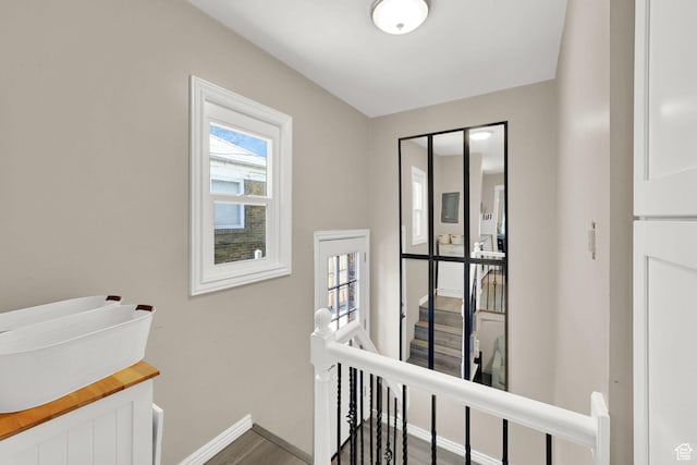2883 S Brinker Ave E, Ogden, UT 84403 - hallway featuring an upstairs landing, baseboards, and wood finished floors