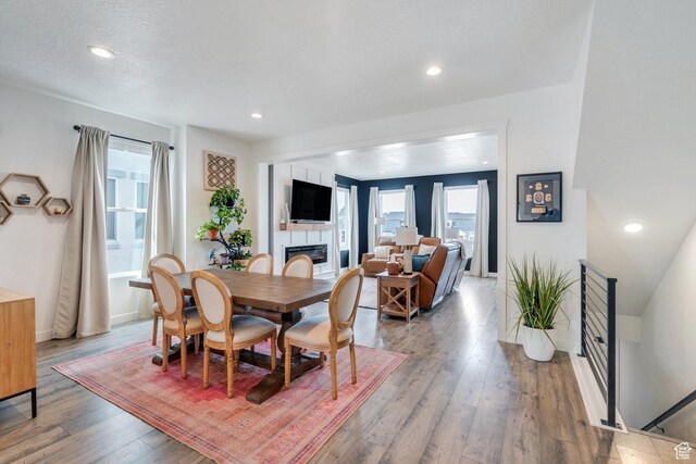 6439 W S Jordan Pkwy, South Jordan, UT 84009 - dining area featuring a fireplace, wood finished floors, recessed lighting, and baseboards