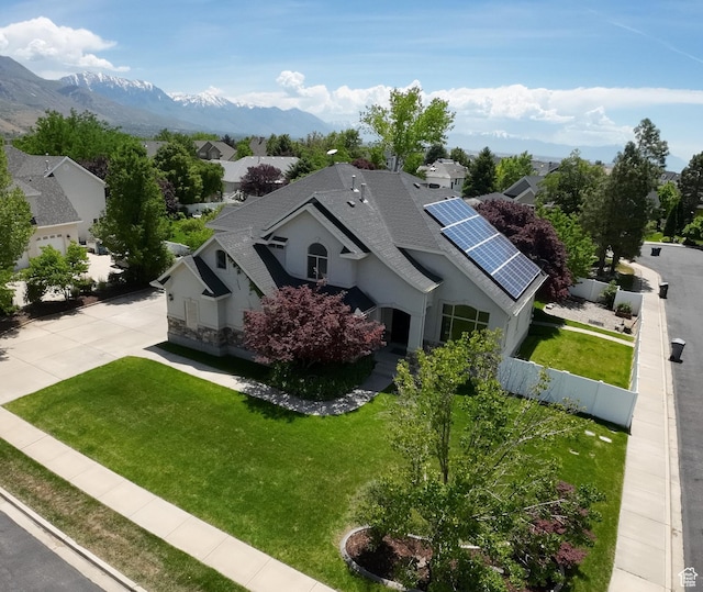 1162 E 1180 N, American Fork, UT 84003 - view of front of home with roof with shingles, roof mounted solar panels, driveway, a mountain view, and stucco siding